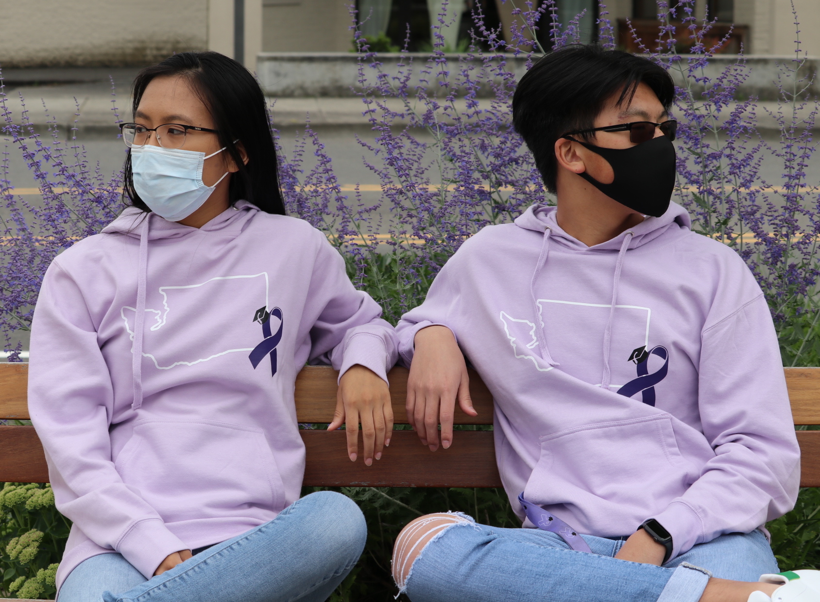 WASCAA Sweatshirts worn by students on bench